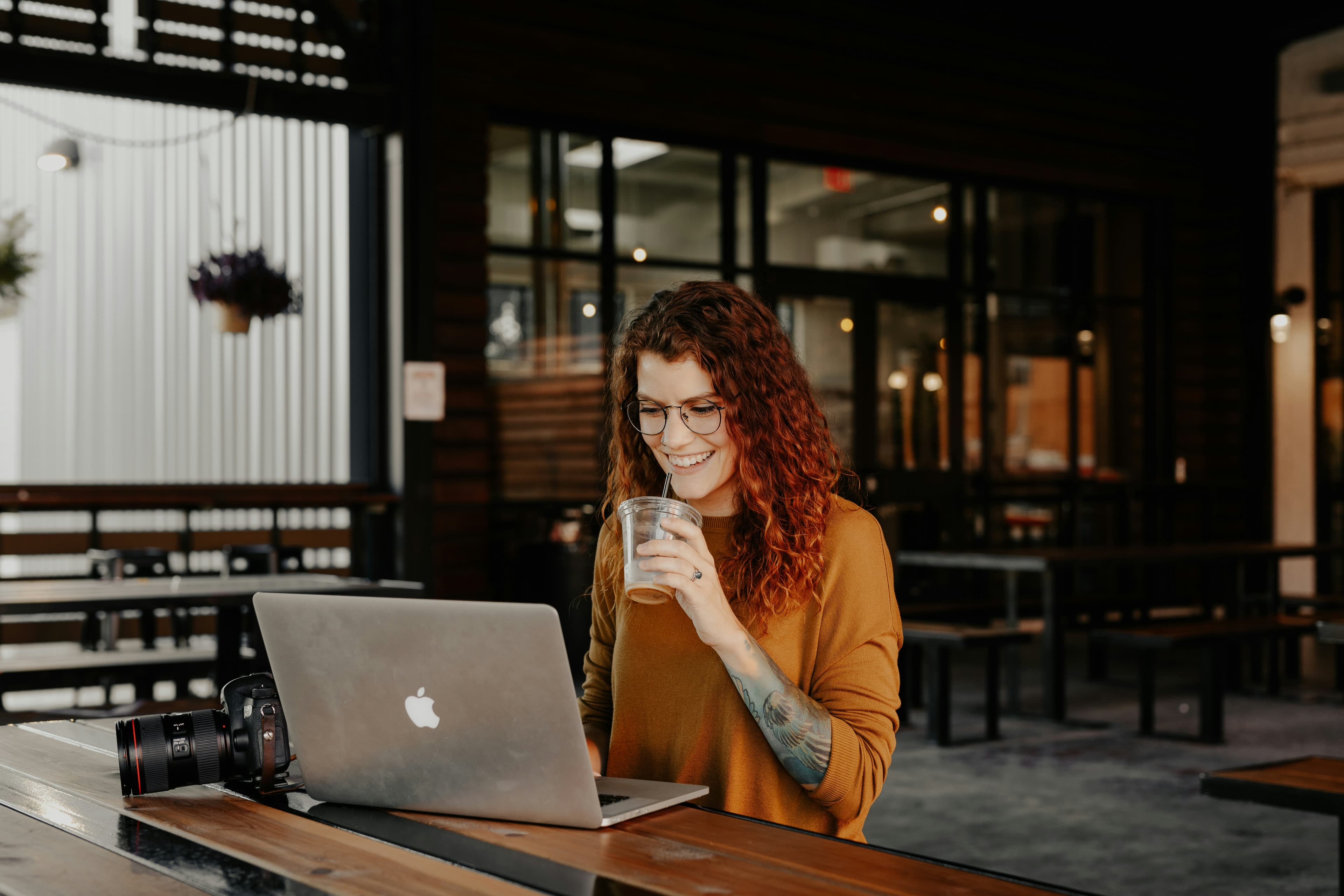 A teammate smiling while working on their laptop